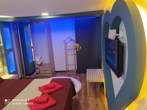 a room with a bed and a tv and a ladder at The Sweet Building Esso in Istanbul