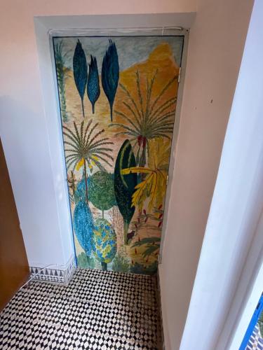 a mural of plants on a wall in a hallway at Riad Isla in Essaouira