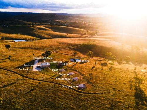 an aerial view of a field with a farm at Glenayr Farm in Windeyer