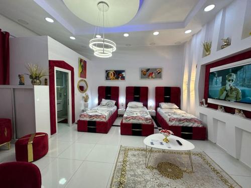 een woonkamer met 2 bedden en een televisie bij Studio near Tirana Airport 2- SELF Check-in Free Parking in Valjiosi