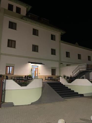 a large building with a skateboard ramp in front of it at Hostel Oltenia in Eforie Sud