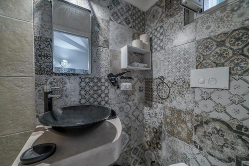 a bathroom with a sink and a mirror at Dimora Dante in Ceglie Messapica