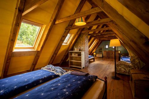 a room with two beds in a attic at Paradise Cottage - Chalupa v Ráji in Čtveřín