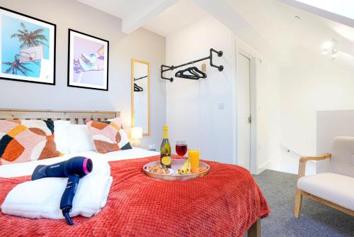 a bedroom with a bed with a tray with drinks on it at Central Buckingham Apartment #6 with Free Parking, Pool Table, Fast Wifi and Smart TV with Netflix by Yoko Property in Buckingham