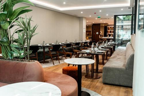 a row of tables and chairs in a restaurant at Next Level Premium Hotels in Lisbon