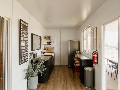 a kitchen with a sink and a refrigerator at Glenayr Farm in Windeyer