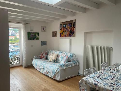 a living room with a couch and a window at La Finestra sul Mare in Lerici