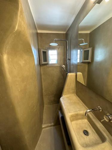 a bathroom with a sink and a shower at Naoussa Center Home in Naousa