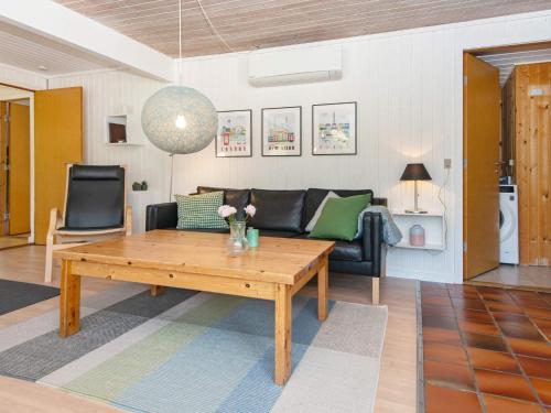 a living room with a table and a couch at 7 person holiday home in Grenaa in Grenå