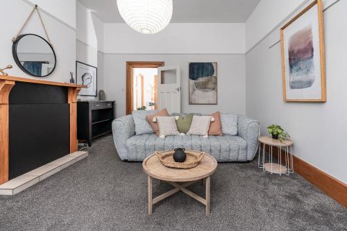 a living room with a couch and a table at Esplanade Apartments in Dunedin