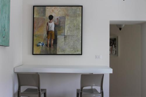 a painting of a boy with a dog on a wall at B&B Casa Benvenuto in Diamante
