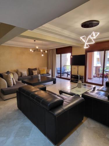 a living room with a couch and a table at Résidence Prestige in Marrakesh