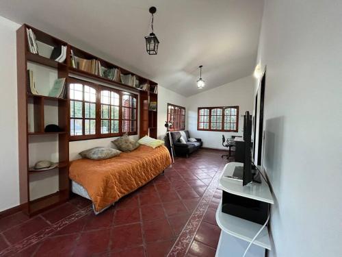 a bedroom with a bed and a flat screen tv at Don Norber, hermosa casa de descanso. Río Ceballos in Río Ceballos