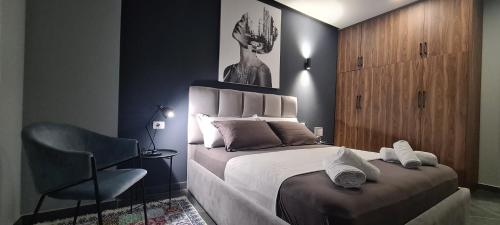a bedroom with a bed and a chair in it at Ermar Apartment 2 in Golem