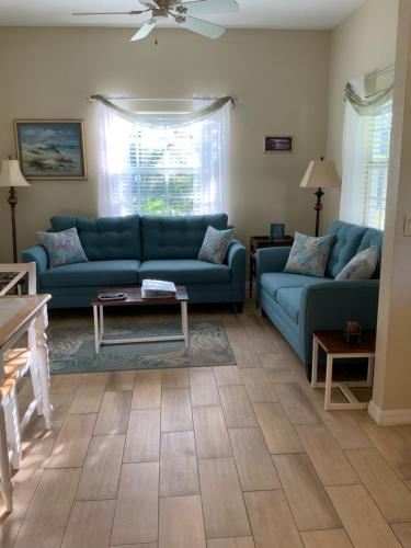a living room with two blue couches and a table at Venetian Vacation in Venice