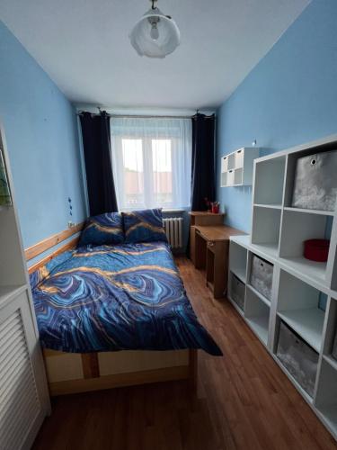 a bedroom with a bed and a desk in it at Apartament pod Honem in Cisna