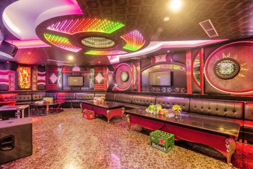 a bar with a couch and tables in a room at Muong Thanh Luxury Can Tho Hotel in Can Tho
