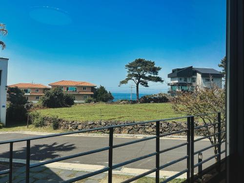 a view of the ocean from a house balcony at Aewol Bada Poomeun Property in Jeju