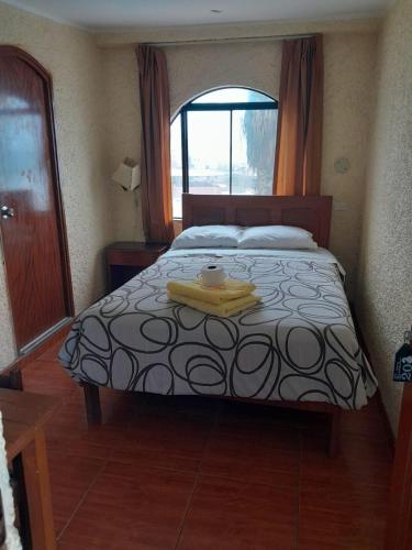 a bedroom with a bed with a tray on it at HOTEL CHORRILLOS BEACH in Barranca