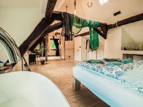 a bedroom with a bed and a bath tub at Cosy holiday home in Sankt Goarshausen with barbecue in Sankt Goarshausen