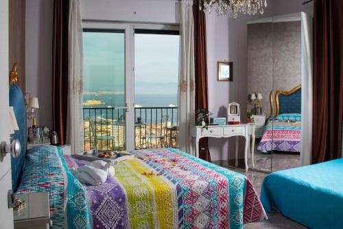 a bedroom with two beds and a view of the ocean at Nido Dei Gabbiani in Naples