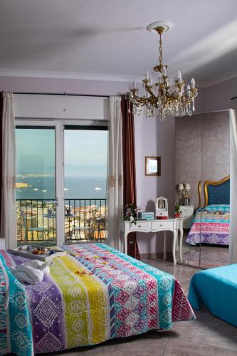a bedroom with a bed and a chandelier at Nido Dei Gabbiani in Naples
