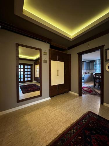 a living room with a large mirror and a hallway at İsra Suit in Trabzon