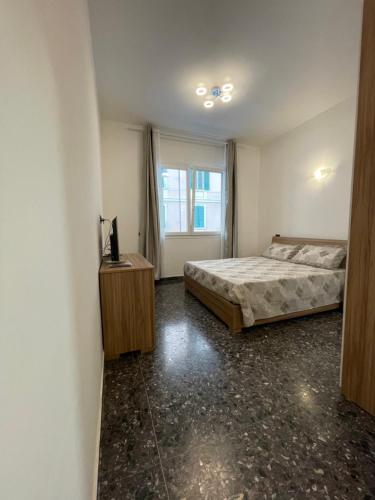 a bedroom with a bed and a window at Due passi dal mare in Savona
