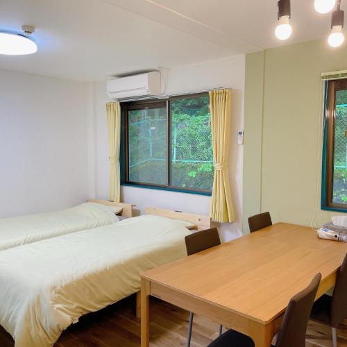 a room with two beds and a table and a window at Cate no mori - Vacation STAY 52818v in Shime