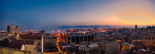 a view of a city at sunset at Hotel Regina Margherita in Cagliari