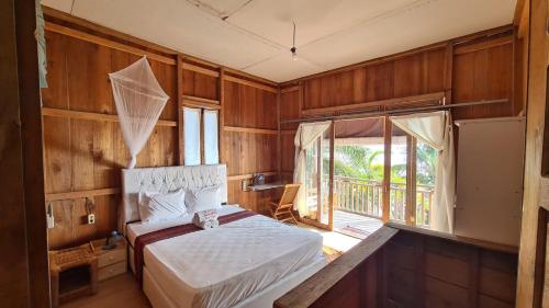 a bedroom with a bed and a large window at Panorama Ekas in Ekas
