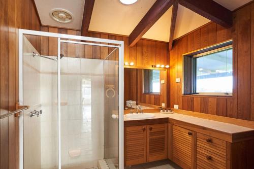 a bathroom with a shower and a sink at Wandin Valley Estate in Lovedale