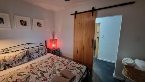 a bedroom with a bed and a red lamp at The Good Life - Two Bedroom Garden Apartment in Port Pirie