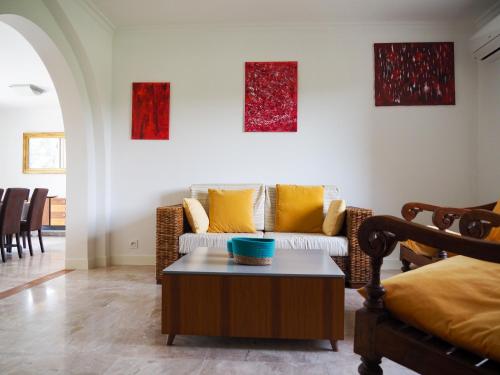 a living room with a couch and a coffee table at Mas Grenadine, magnifique villa du Piémont Cévenol in Sauve