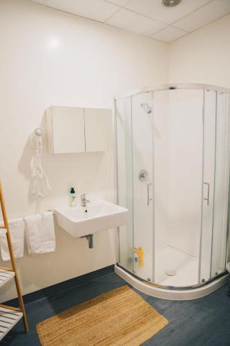 a bathroom with a shower and a sink at Liberty Apartment Hotel in Wellington