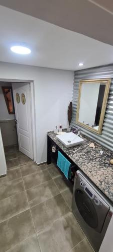 a bathroom with a sink and a mirror at Finca san benito in Puerto Madryn