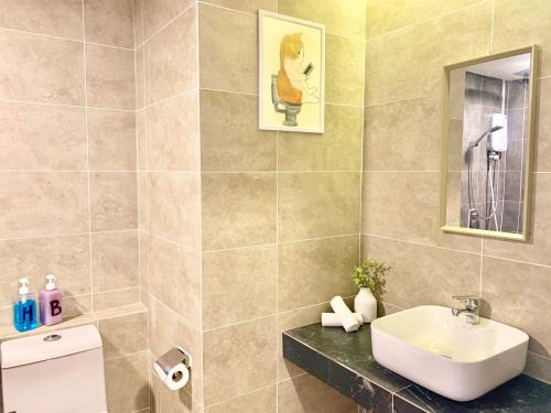 a bathroom with a sink and a toilet at Deco Home @ Aru Suites in Kota Kinabalu