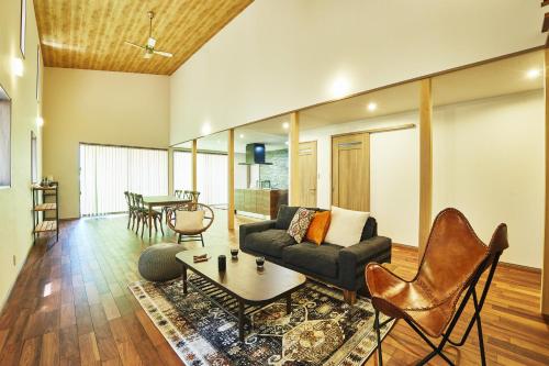 a living room with a couch and a table at GLAMPING GATE 奈良 in Nara