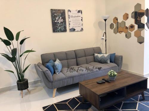 a living room with a couch and a coffee table at Studio Unit - Little Fox Nest KLIA Sepang and Gamuda SplashMania in Sepang