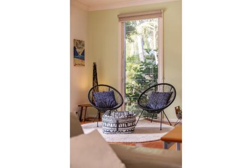 a living room with chairs and a window at The Beach House at Lizzie in Elizabeth Beach