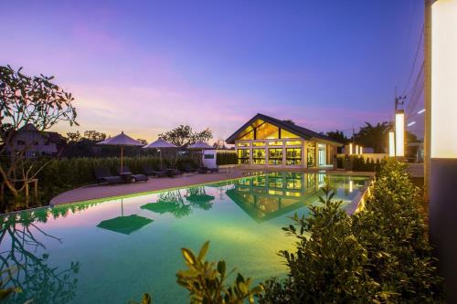 a swimming pool in front of a house at MOST Family 40 Ubon in Ubon Ratchathani