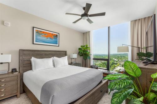 a bedroom with a bed and a large window at 'Cloud 10' A Luxury Downtown Condo with Panoramic City and Mountain Views at Arras Vacation Rentals in Asheville