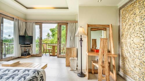 a bedroom with a bed and a balcony at KajaNe Yangloni at Ubud Bali in Ubud