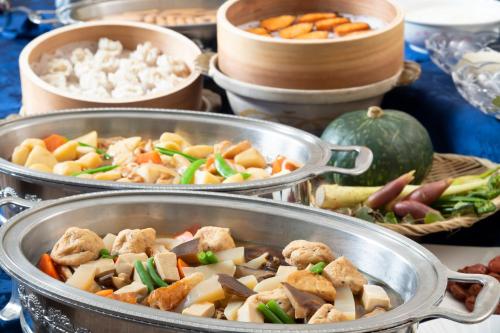 two metal pans filled with food on a table at Hotel Symphony Annex Sagae Onsen in Sagae