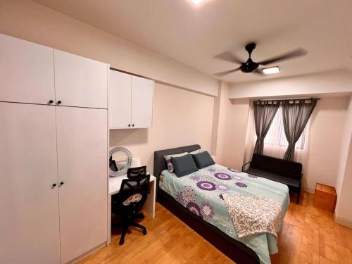 a bedroom with a bed and a ceiling fan at Radia Residence Bukit Jelutong, Shah Alam in Shah Alam