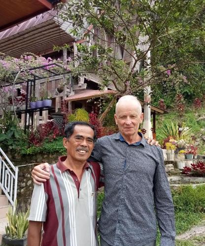two men standing next to each other in front of a house at NUANSA HOMESTAY Authentic&Hospitality in Rantepao