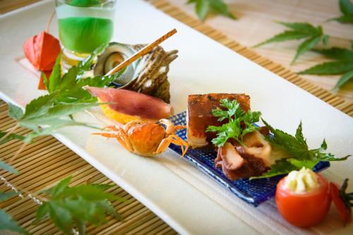 a white plate with food on a table at Hotel Symphony Annex Sagae Onsen in Sagae