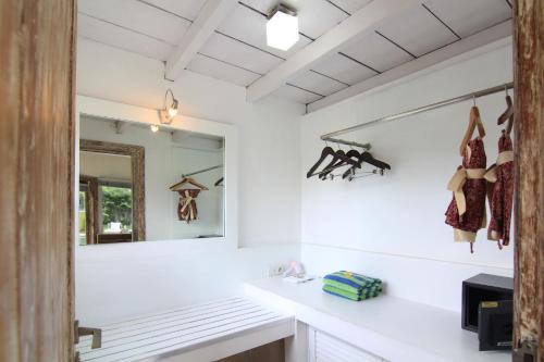 a bathroom with white walls and a mirror at Villa Seminyak Estate & Spa - By Astadala in Seminyak