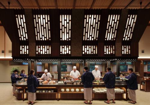 a group of chefs preparing food in a kitchen at Hakodate Hotel Banso in Hakodate