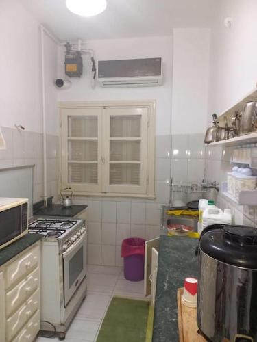 a kitchen with a stove top oven in a kitchen at cousy apartment in Cairo